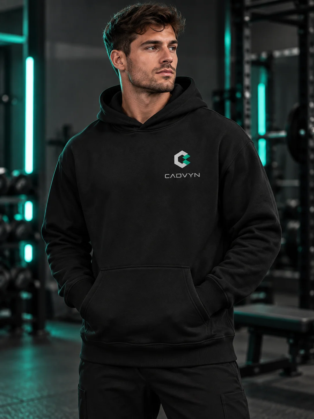 Model wearing the black CADVYN Relax Hood in a gym